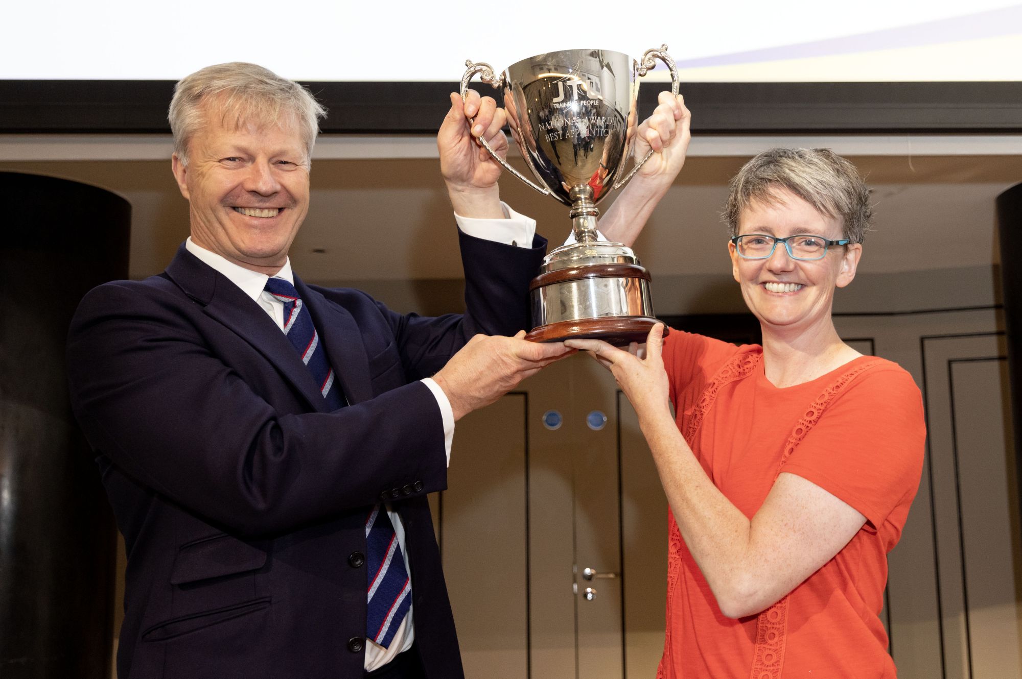 Amy Lister and JTL CEO Chris Claydon hold the National Awards trophy