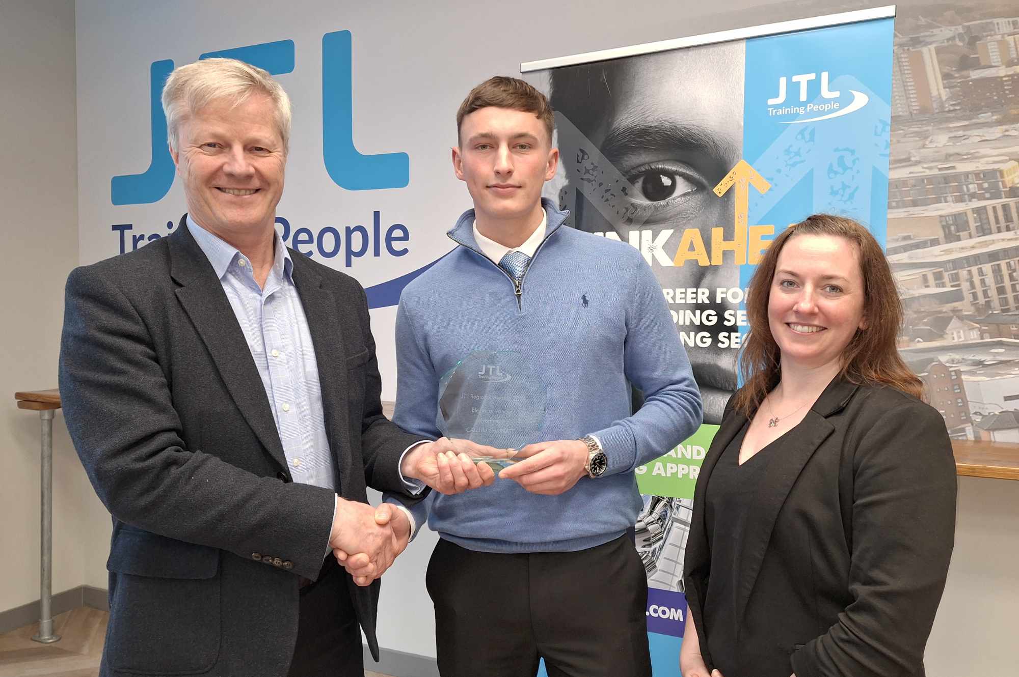 Regional Electrical Award Winner Callum Sharratt from Blackpool being presented with his trophy by Chris Claydon and Clair Bradley of JTL